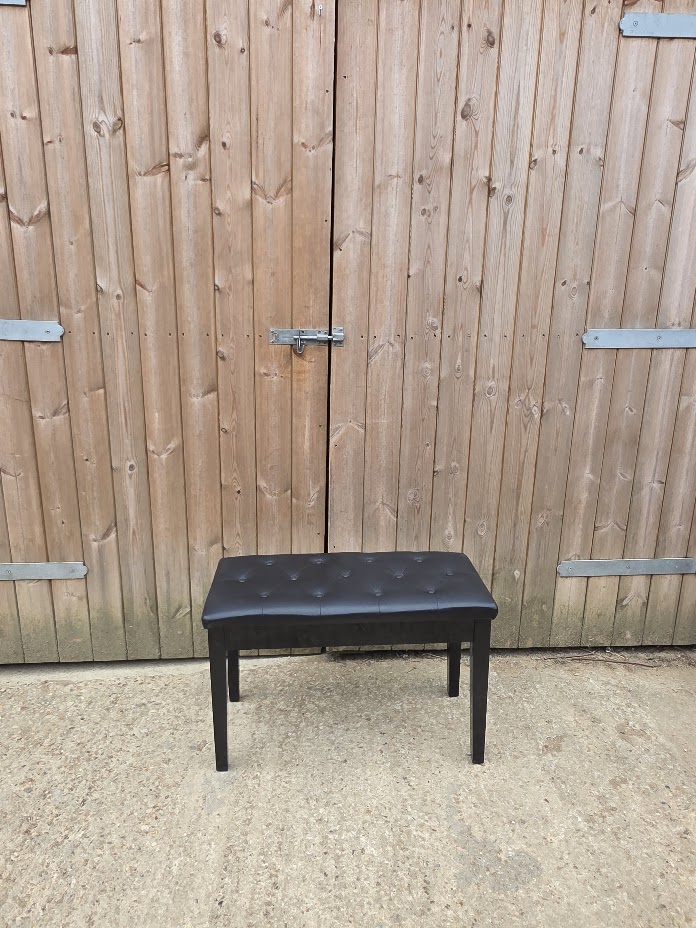 Black faux-leather padded piano stool