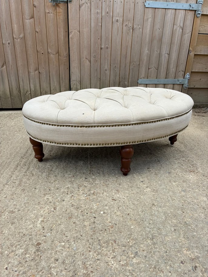 Large oval button-tufted linen ottoman seat